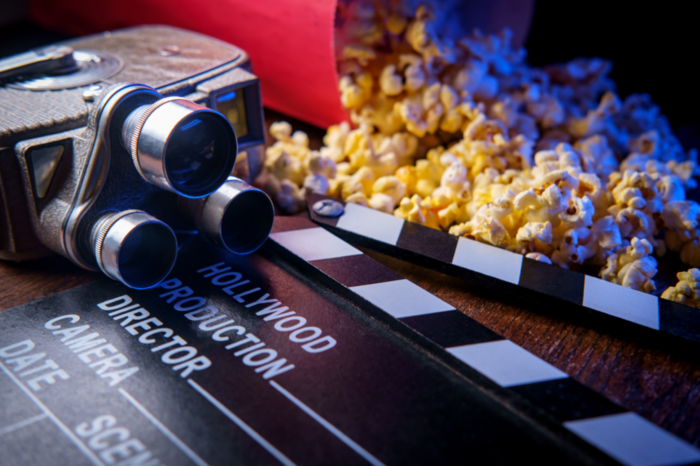 Take, old-school film camera and popcorn displayed on a table